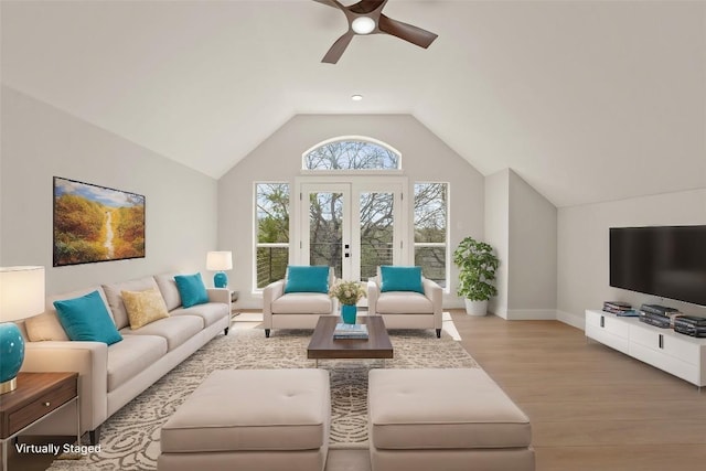 living room featuring french doors, vaulted ceiling, ceiling fan, wood finished floors, and baseboards