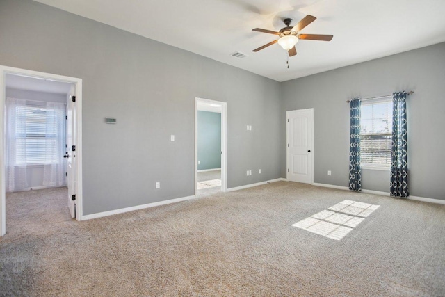 unfurnished bedroom featuring a ceiling fan, carpet, visible vents, and baseboards