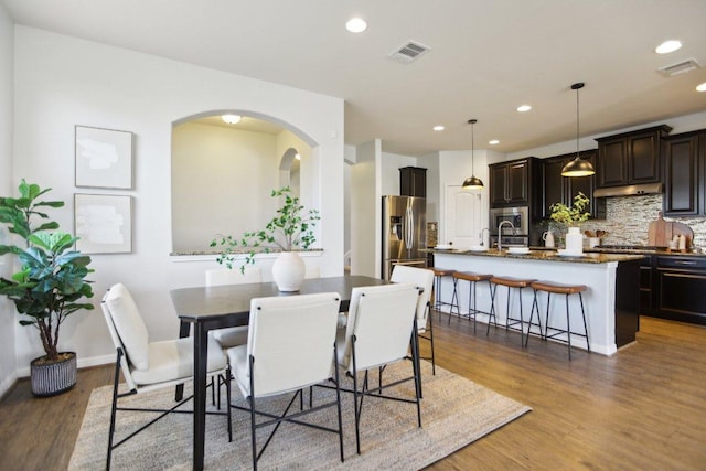 dining room featuring recessed lighting, visible vents, and wood finished floors