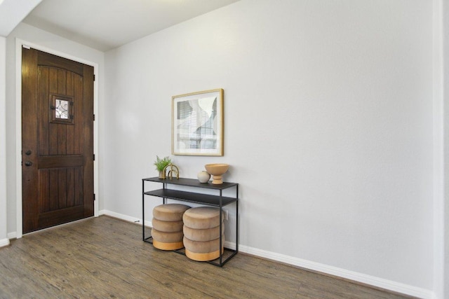 entrance foyer featuring wood finished floors and baseboards