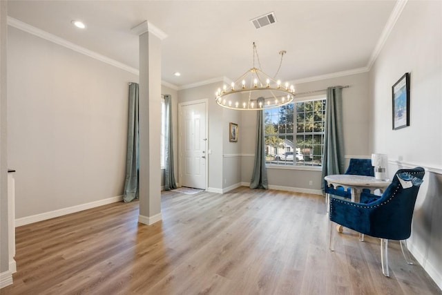 sitting room featuring decorative columns, light wood finished floors, visible vents, ornamental molding, and baseboards