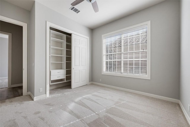 unfurnished bedroom with ceiling fan, visible vents, baseboards, a closet, and carpet