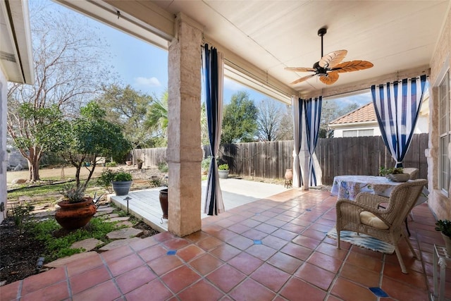 view of patio / terrace with ceiling fan and fence