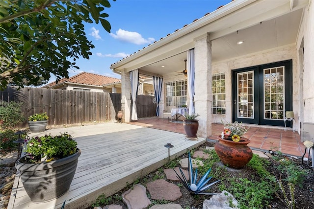 wooden terrace with a ceiling fan and fence