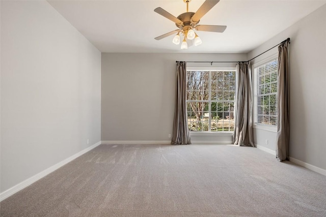 empty room with a ceiling fan, carpet flooring, and baseboards