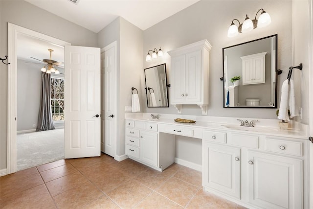 full bathroom featuring double vanity, baseboards, a sink, and tile patterned floors