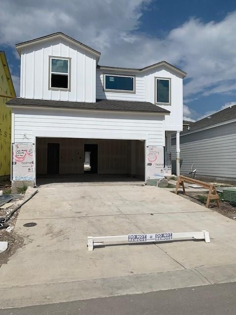 view of front of house with driveway, board and batten siding, and an attached garage