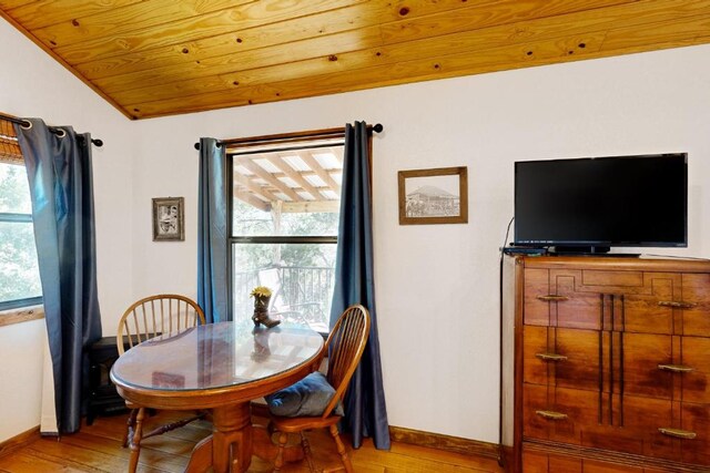 961 Buttercup Ln, Wimberley, TX 78676 - dining area with baseboards, light wood-style flooring, plenty of natural light, vaulted ceiling, and wooden ceiling