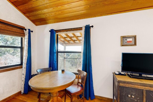 961 Buttercup Ln, Wimberley, TX 78676 - dining room featuring wood finished floors, baseboards, plenty of natural light, lofted ceiling, and wood ceiling