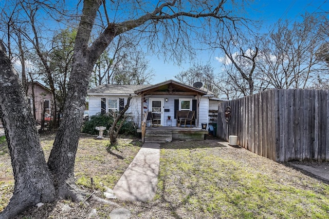 view of front of house with fence and a front lawn