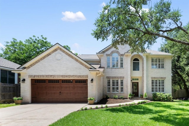 view of front of house featuring driveway, fence, and brick siding