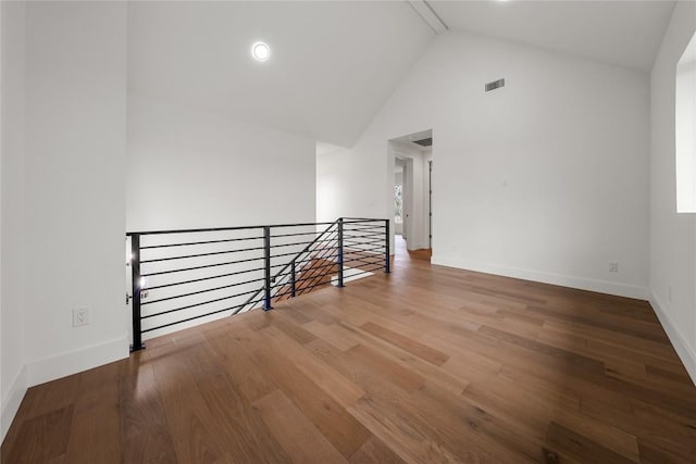 12120 Fitzhugh Pl, Dripping Springs, TX 78620 - empty room featuring wood finished floors, high vaulted ceiling, and baseboards