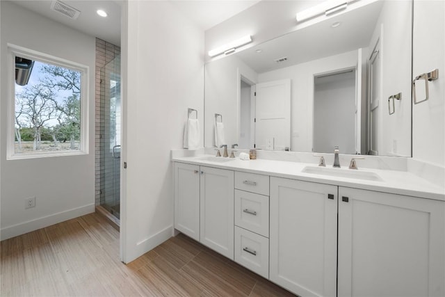 12120 Fitzhugh Pl, Dripping Springs, TX 78620 - full bath with double vanity, baseboards, a stall shower, and recessed lighting