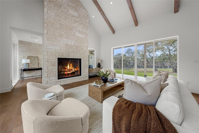 12120 Fitzhugh Pl, Dripping Springs, TX 78620 - living area with high vaulted ceiling, beamed ceiling, wood finished floors, a fireplace, and recessed lighting