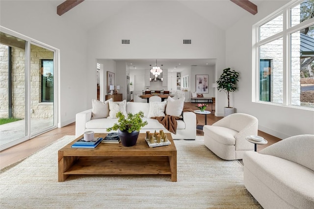 12120 Fitzhugh Pl, Dripping Springs, TX 78620 - living area featuring high vaulted ceiling, beamed ceiling, wood finished floors, and baseboards