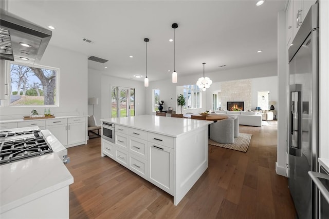 12120 Fitzhugh Pl, Dripping Springs, TX 78620 - kitchen featuring high end fridge, dark wood-type flooring, white cabinets, open floor plan, and recessed lighting