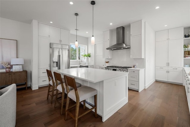 12120 Fitzhugh Pl, Dripping Springs, TX 78620 - kitchen with wall chimney exhaust hood, built in fridge, open shelves, a kitchen island, and dark wood-style flooring