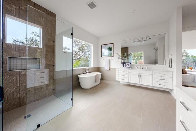 12120 Fitzhugh Pl, Dripping Springs, TX 78620 - bathroom featuring a walk in shower, vanity, a soaking tub, and tile patterned floors