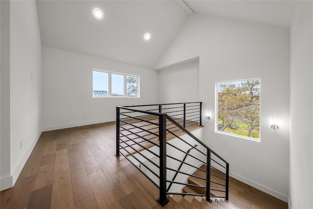 12120 Fitzhugh Pl, Dripping Springs, TX 78620 - staircase featuring high vaulted ceiling, baseboards, wood finished floors, and recessed lighting