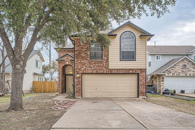 traditional-style house with concrete driveway, brick siding, fence, and an attached garage