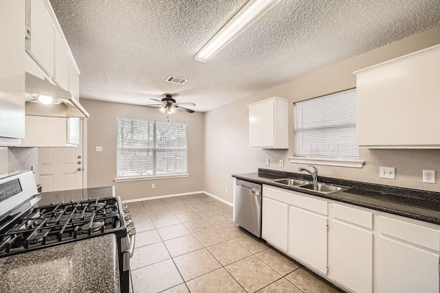 kitchen with visible vents, white cabinets, dark countertops, appliances with stainless steel finishes, and a sink