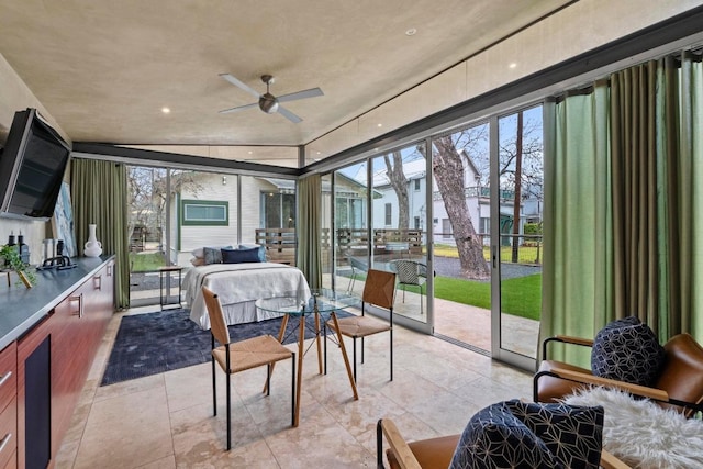 sunroom / solarium featuring a ceiling fan and a healthy amount of sunlight