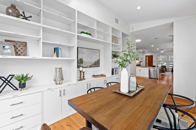 dining area featuring light wood finished floors, visible vents, and recessed lighting