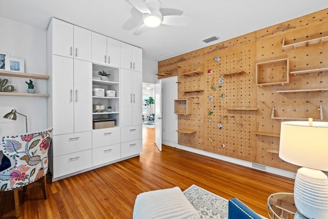 interior space featuring visible vents, ceiling fan, and light wood-style flooring