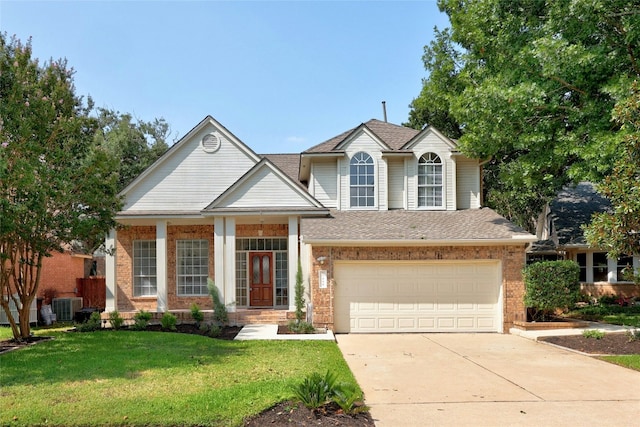 traditional-style house featuring brick siding, concrete driveway, a front yard, central AC, and a garage