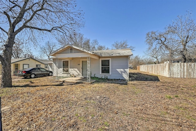 bungalow-style house with fence