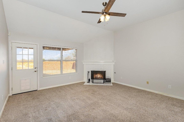 unfurnished living room featuring lofted ceiling, a brick fireplace, carpet, and baseboards