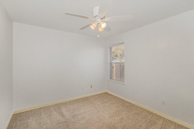 empty room featuring baseboards, ceiling fan, and light colored carpet