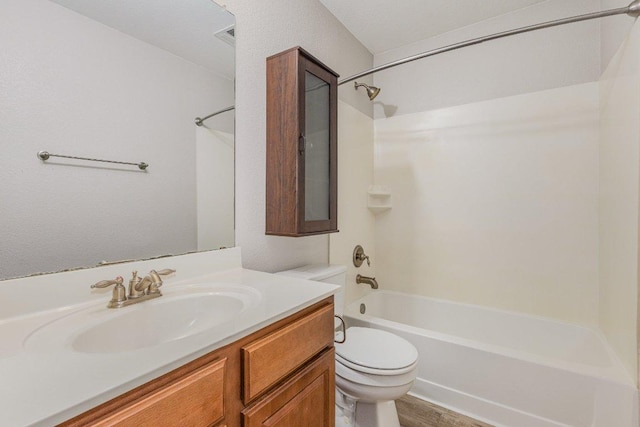 full bathroom with shower / bath combination, toilet, wood finished floors, and vanity