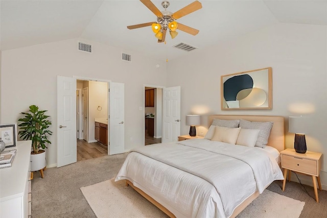 bedroom featuring light carpet, visible vents, and vaulted ceiling