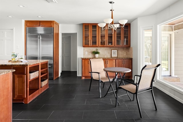 dining room with baseboards, recessed lighting, visible vents, and a notable chandelier