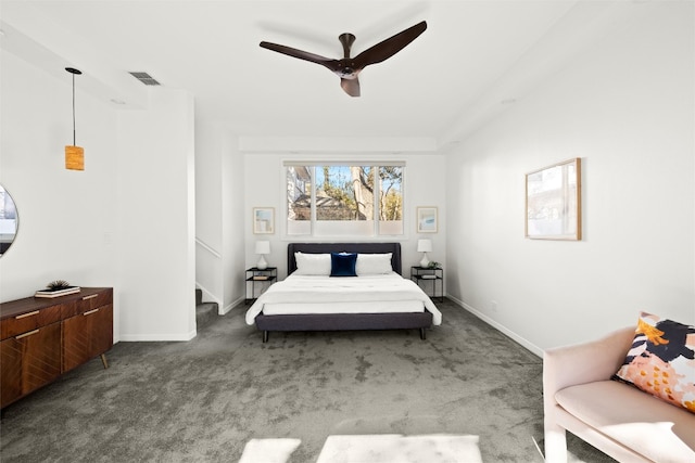 carpeted bedroom featuring a ceiling fan, visible vents, and baseboards