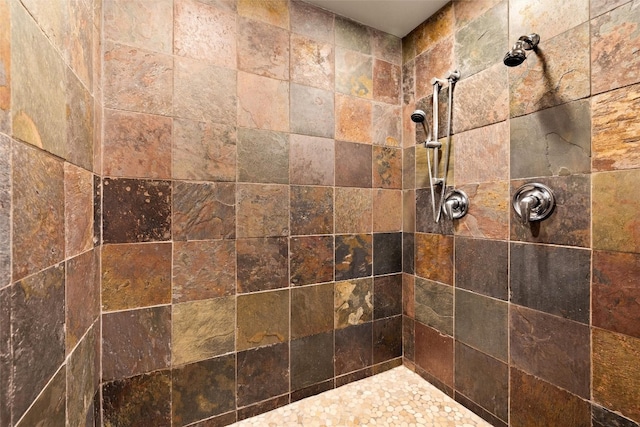 interior details with a tile shower