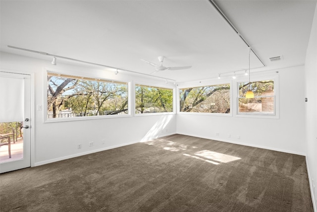 unfurnished sunroom featuring visible vents, rail lighting, and a ceiling fan