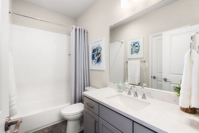 bathroom featuring vanity, toilet, and shower / bath combo with shower curtain