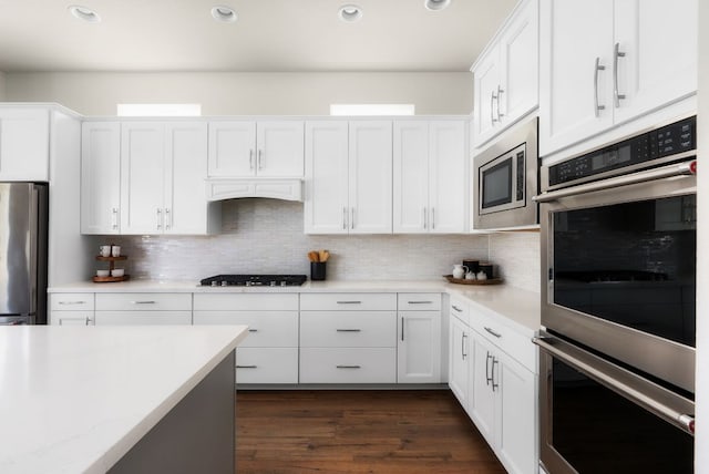 kitchen with appliances with stainless steel finishes, light countertops, and white cabinetry