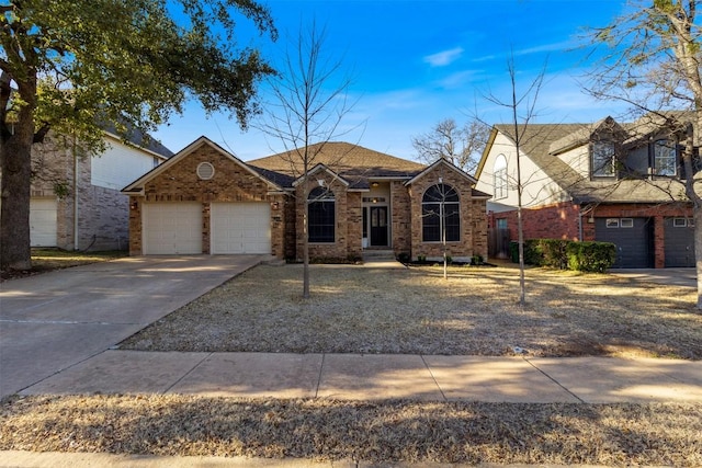 view of front facade with a garage, driveway, and brick siding