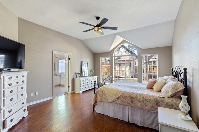 bedroom with baseboards, connected bathroom, lofted ceiling, ceiling fan, and wood finished floors