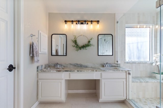 full bathroom with a stall shower, tile patterned floors, a sink, and double vanity