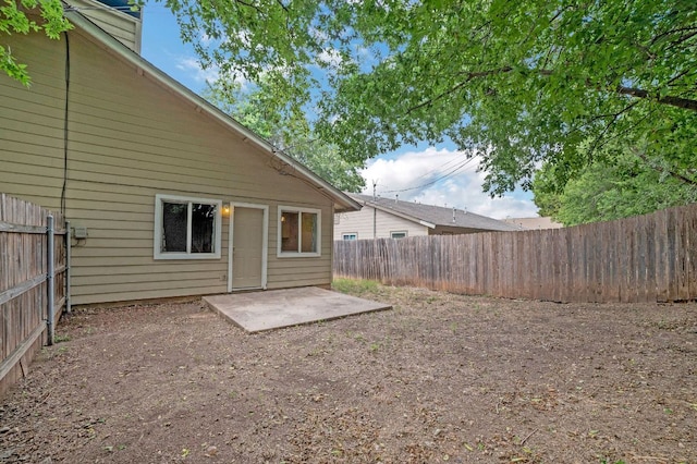 back of house featuring a fenced backyard