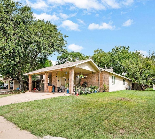exterior space featuring driveway, a front lawn, and brick siding