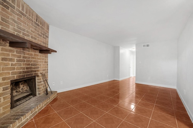 unfurnished living room featuring visible vents, baseboards, tile patterned flooring, and a fireplace