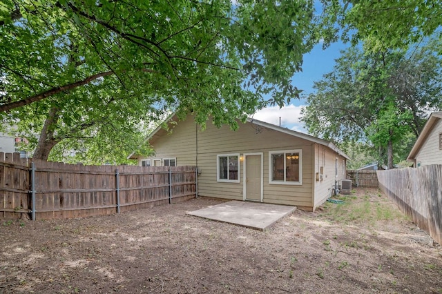 rear view of property featuring a patio and a fenced backyard