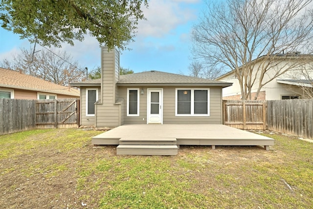 1807 Hollow Tree Blvd, Round Rock, TX 78681 - back of house with a fenced backyard, a chimney, and a deck