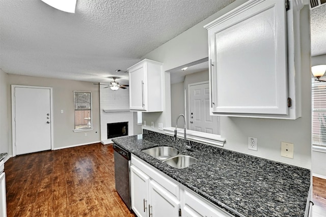 1807 Hollow Tree Blvd, Round Rock, TX 78681 - kitchen with dishwasher, a ceiling fan, a textured ceiling, dark wood-style floors, and white cabinetry