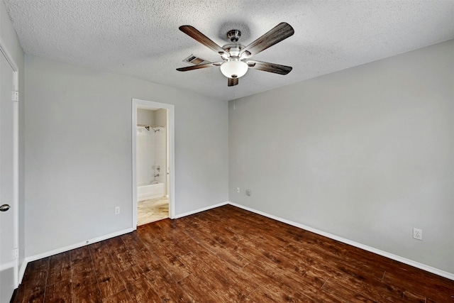1807 Hollow Tree Blvd, Round Rock, TX 78681 - unfurnished bedroom featuring wood finished floors, a textured ceiling, ceiling fan, and connected bathroom